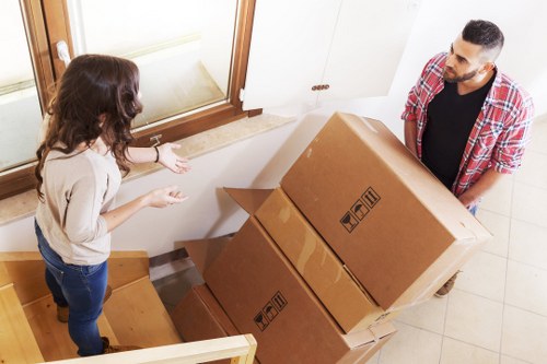Customer moving a boxed item carefully through a storage corridor