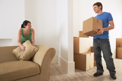 Professional man and van unloading boxes in Earlscourt
